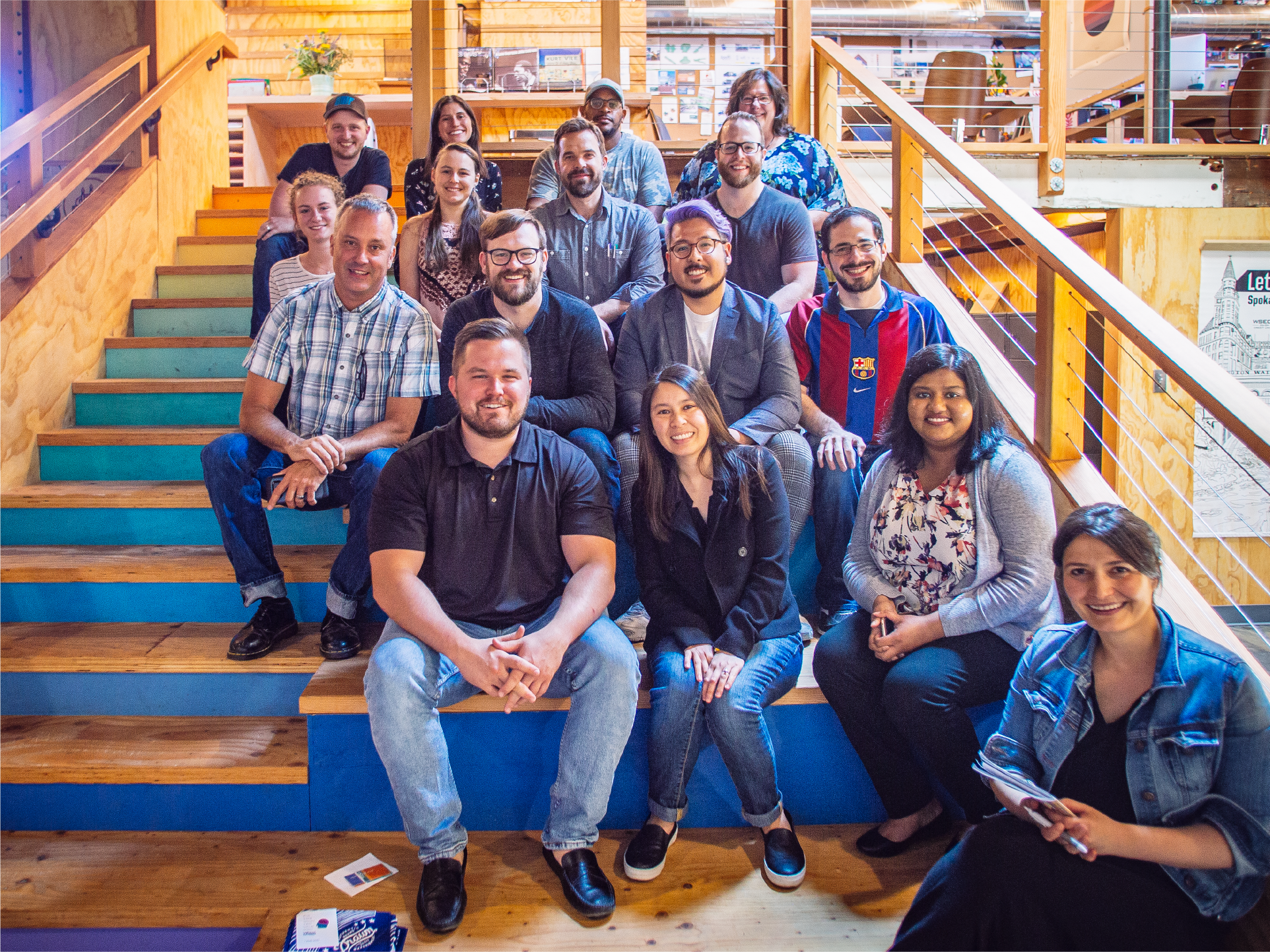Drawn team group photo seated on the wooden stadium stairs of their studio
