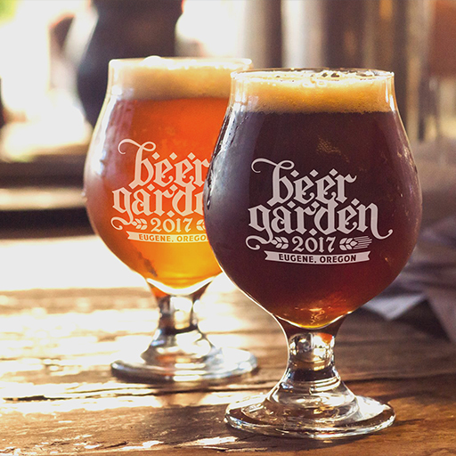 Two stemmed glasses of amber beer etched with the Beergarden 2017 Eugene Oregon logo
