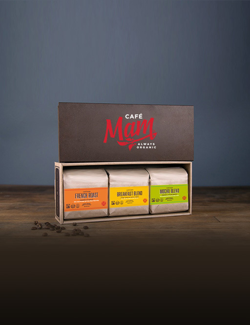 Cafe Mam gift box holding three bags of French Roast, Breakfast Blend and Mocha Blend coffee