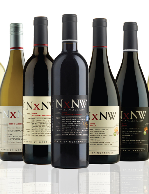 Row of NxNW North by Northwest wine bottles including Chardonnay, Cabernet and Syrah