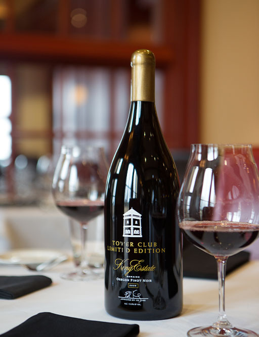 King Estate Tower Club Limited Edition Oregon Pinot Noir bottle with two glasses of red wine