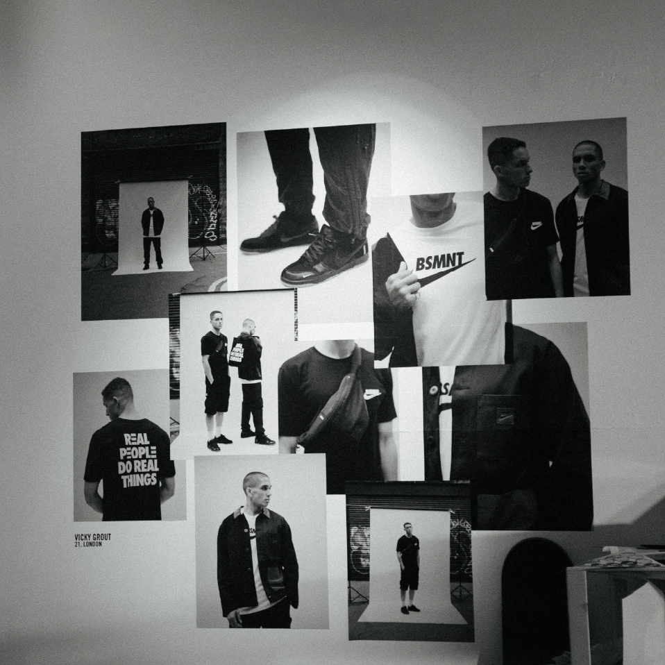 Nike London BSMNT exhibition wall of black-and-white prints including 'Real People Do Real Things'