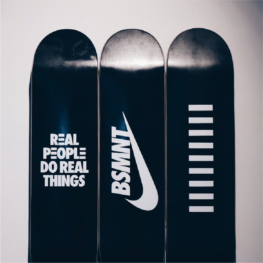 Nike London BSMNT skateboard decks printed 'Real People Do Real Things' and the Nike swoosh