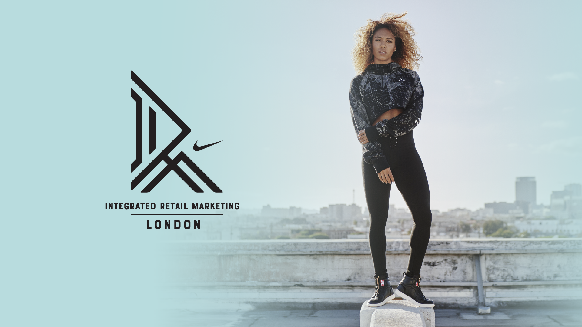 Nike Integrated Retail Marketing London logo beside an athlete standing on a rooftop block