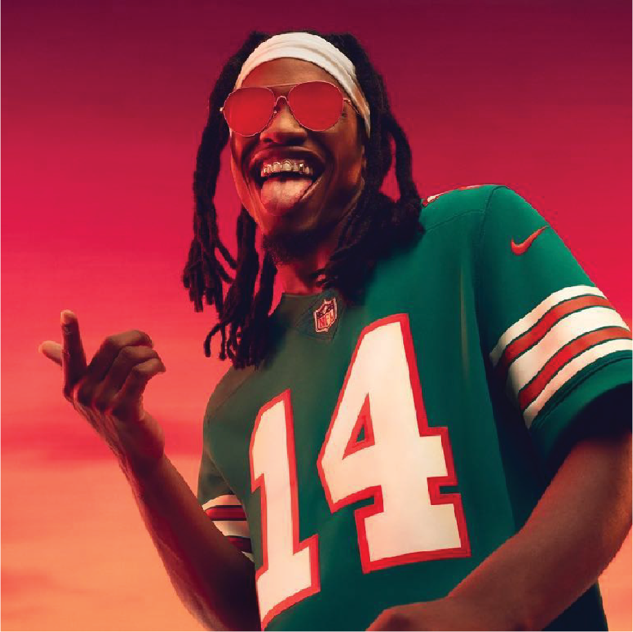 Nike London: smiling man in a green number 14 Nike football jersey against a red backdrop