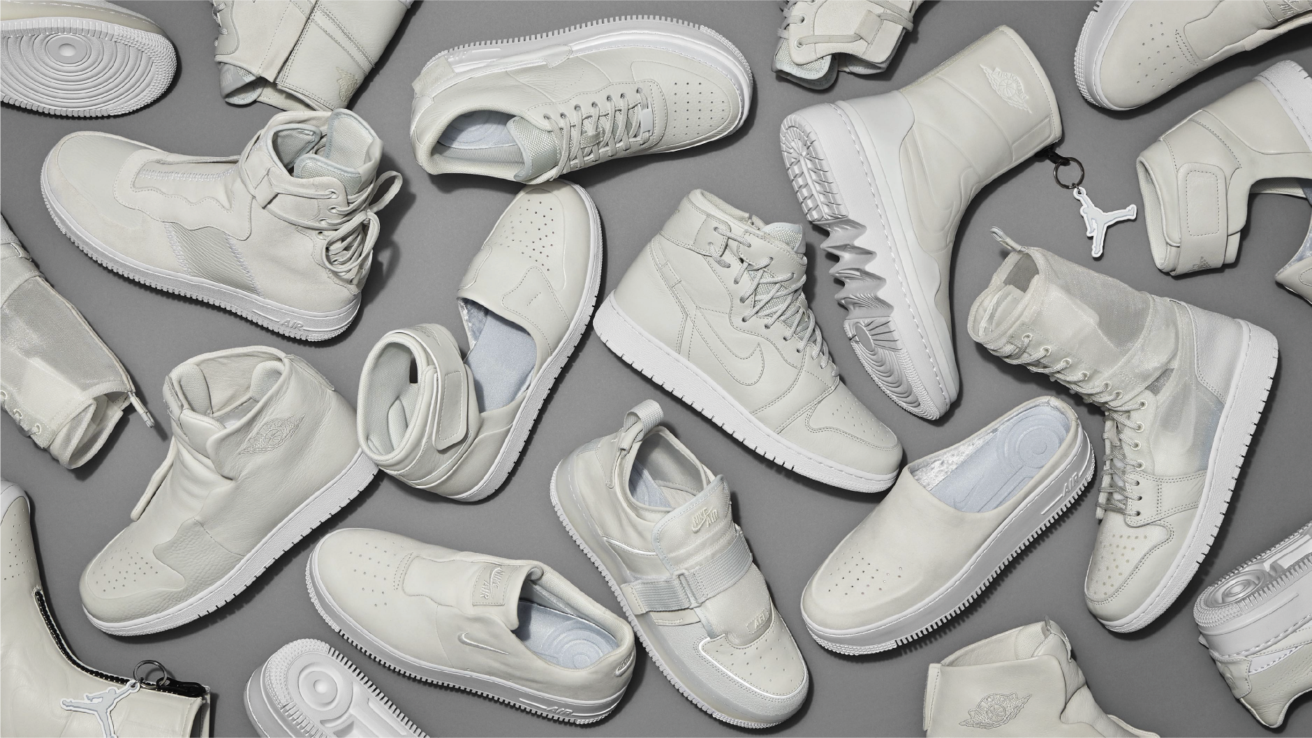 Flat-lay of many all-white Nike Air Force 1 and Air Jordan sneakers on grey, Nike London