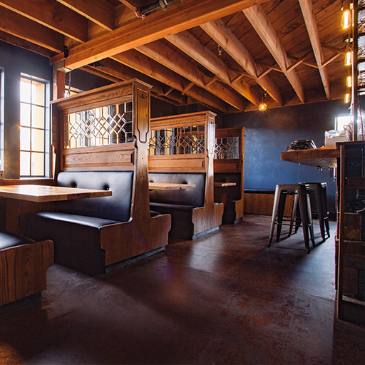 Public House interior with leaded-glass wooden booths, blue walls and stools at a counter