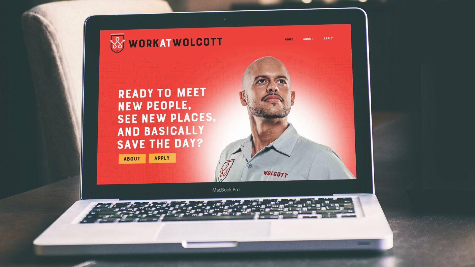 Laptop showing Wolcott recruitment site headline 'Ready to meet new people, save the day?'