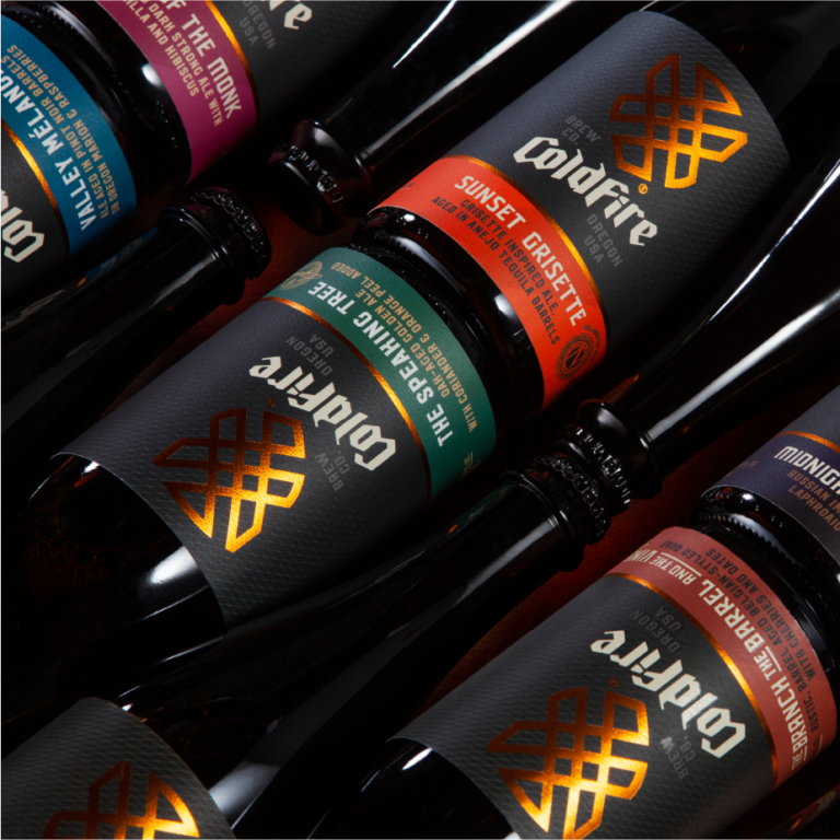 ColdFire Brewing barrel-aged beer bottles with colorful labels arranged in a tight grid