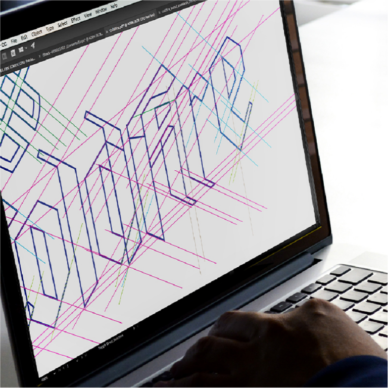 Laptop showing the ColdFire wordmark being built in Illustrator with construction grid lines