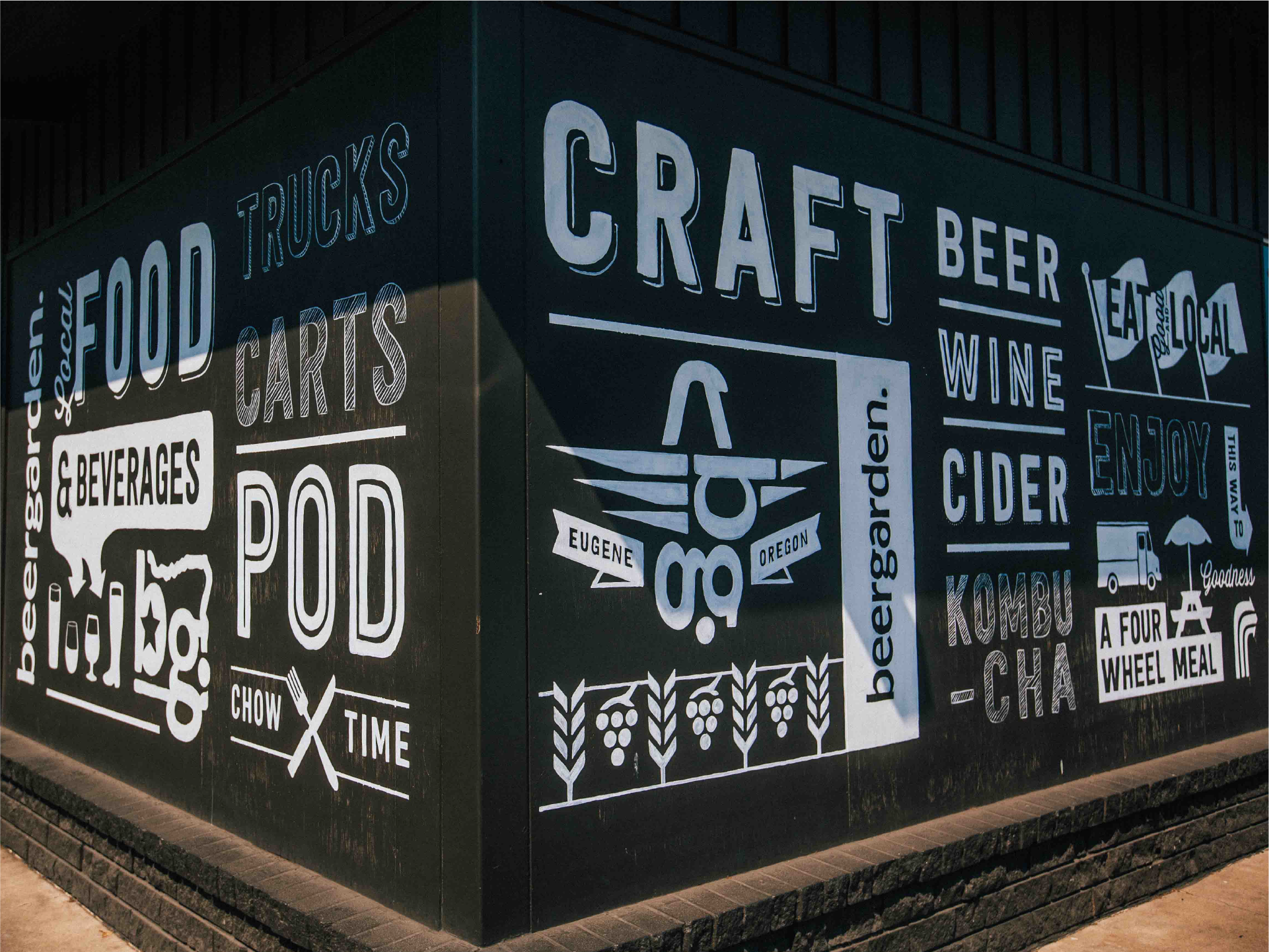 Beergarden building mural reading Craft Beer Wine Cider, Food Trucks Carts Pod, Eugene Oregon