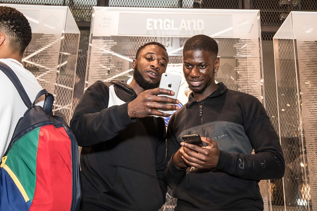 Nike London: two men taking a phone selfie at an England-branded display