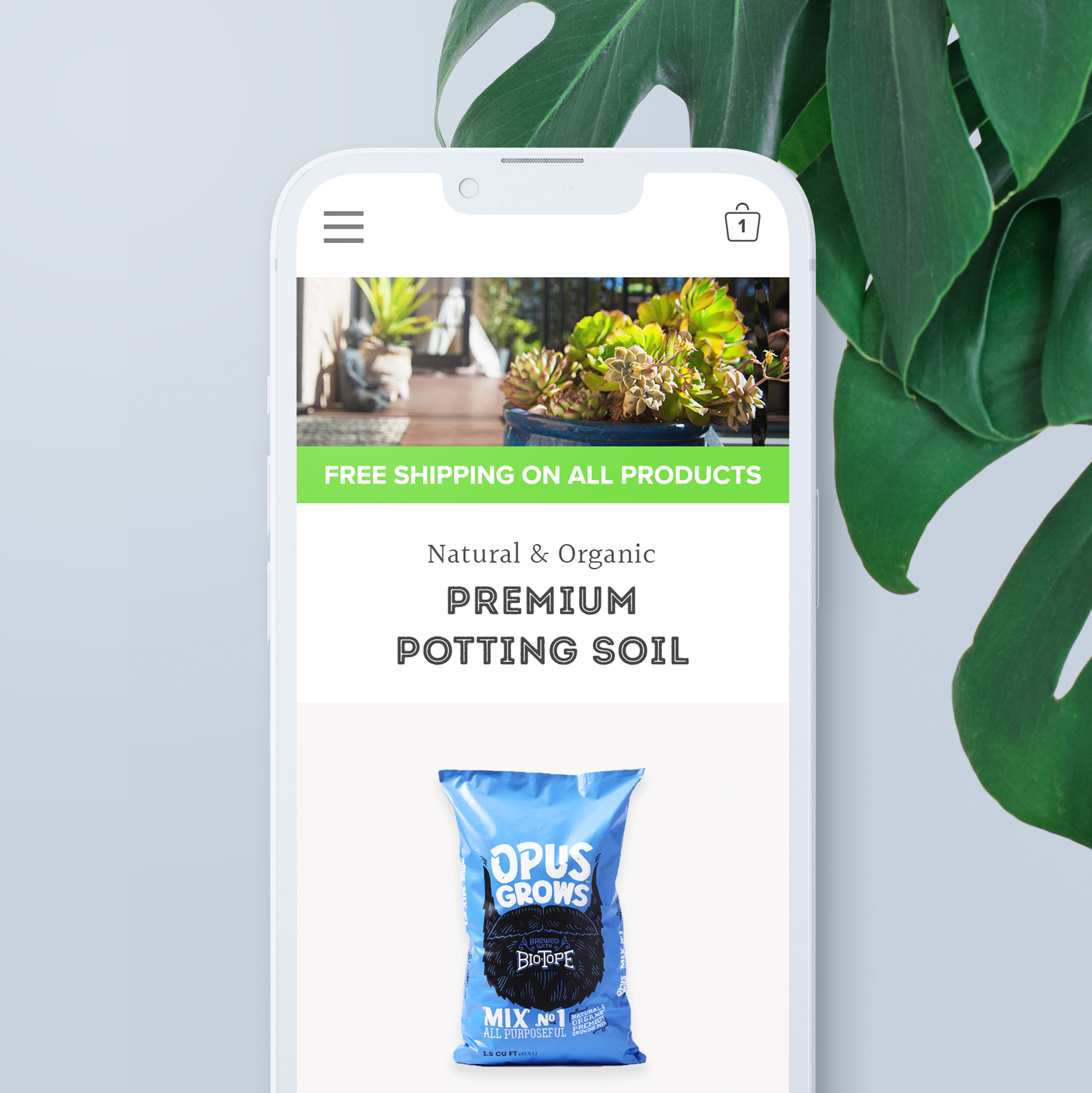 Smartphone showing Opus Grows shop page for Premium Potting Soil beside a monstera leaf