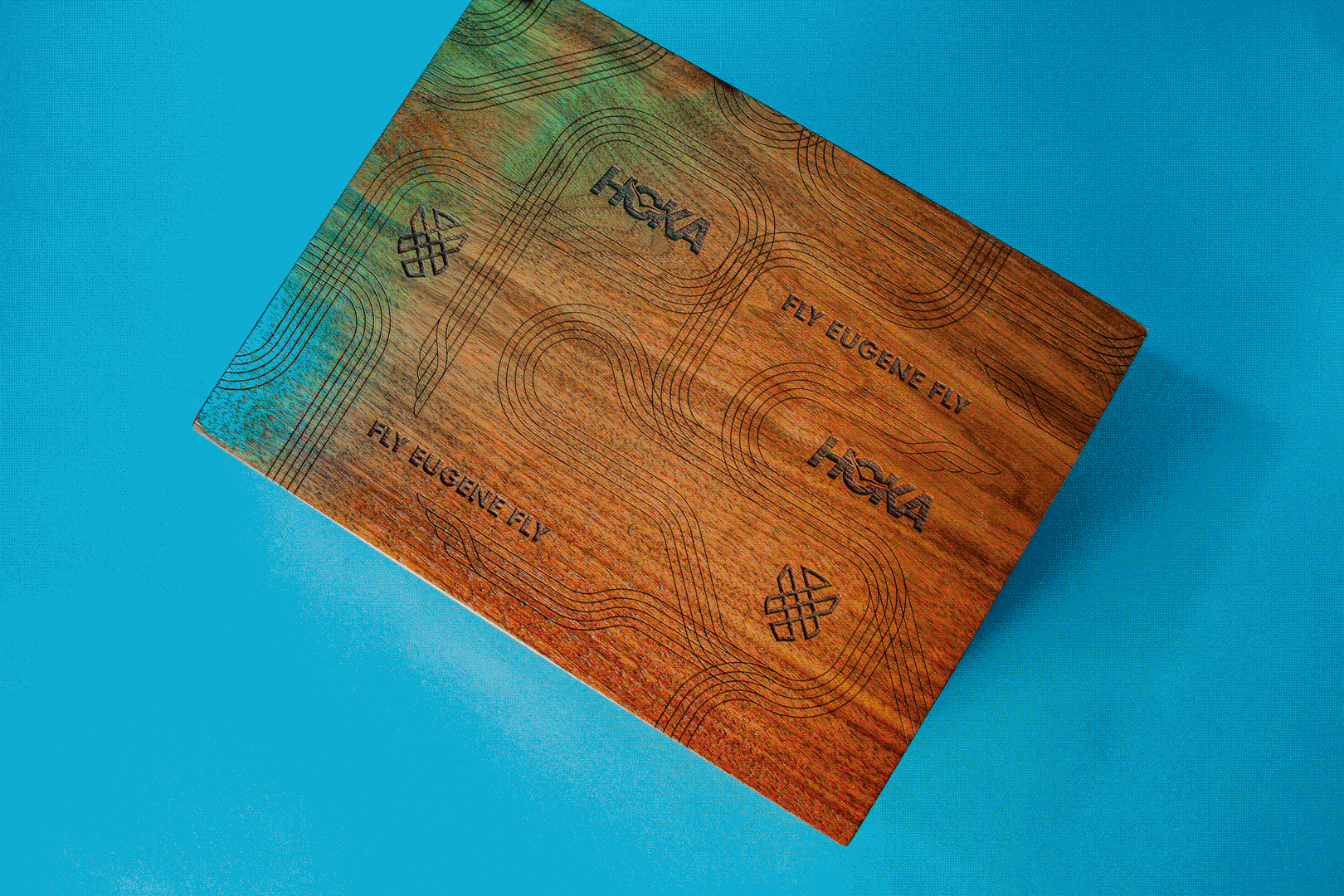 Wood gift box laser-engraved with Hoka and Fly Eugene Fly on a blue background