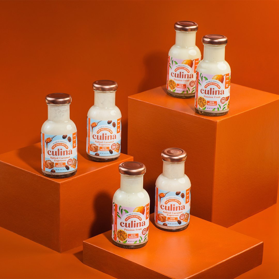 Culina Salted Caramel Espresso and Passion Fruit bottles on orange pedestals