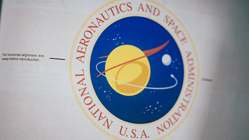 NASA seal printed in a brand guide book, lettered National Aeronautics and Space Administration U.S.A.