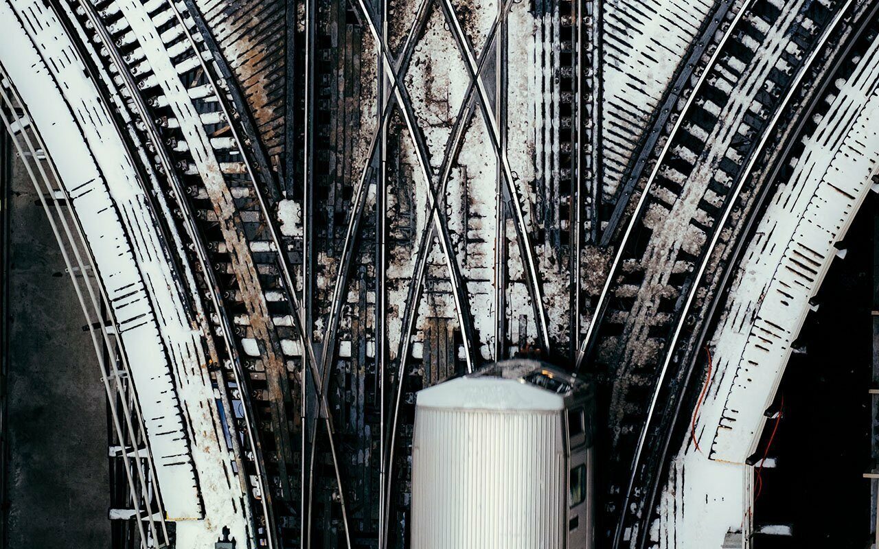 Overhead view of converging railway tracks with a train car at the junction