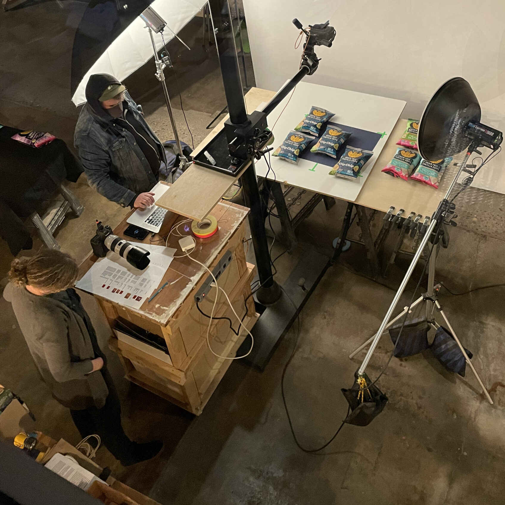 Overhead view of a product photo shoot set with camera rig, lighting and Siete chip bags