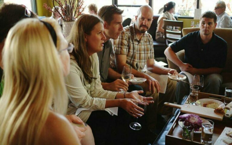 People gathered with drinks in a lounge during an informal Drawn unfocus group session