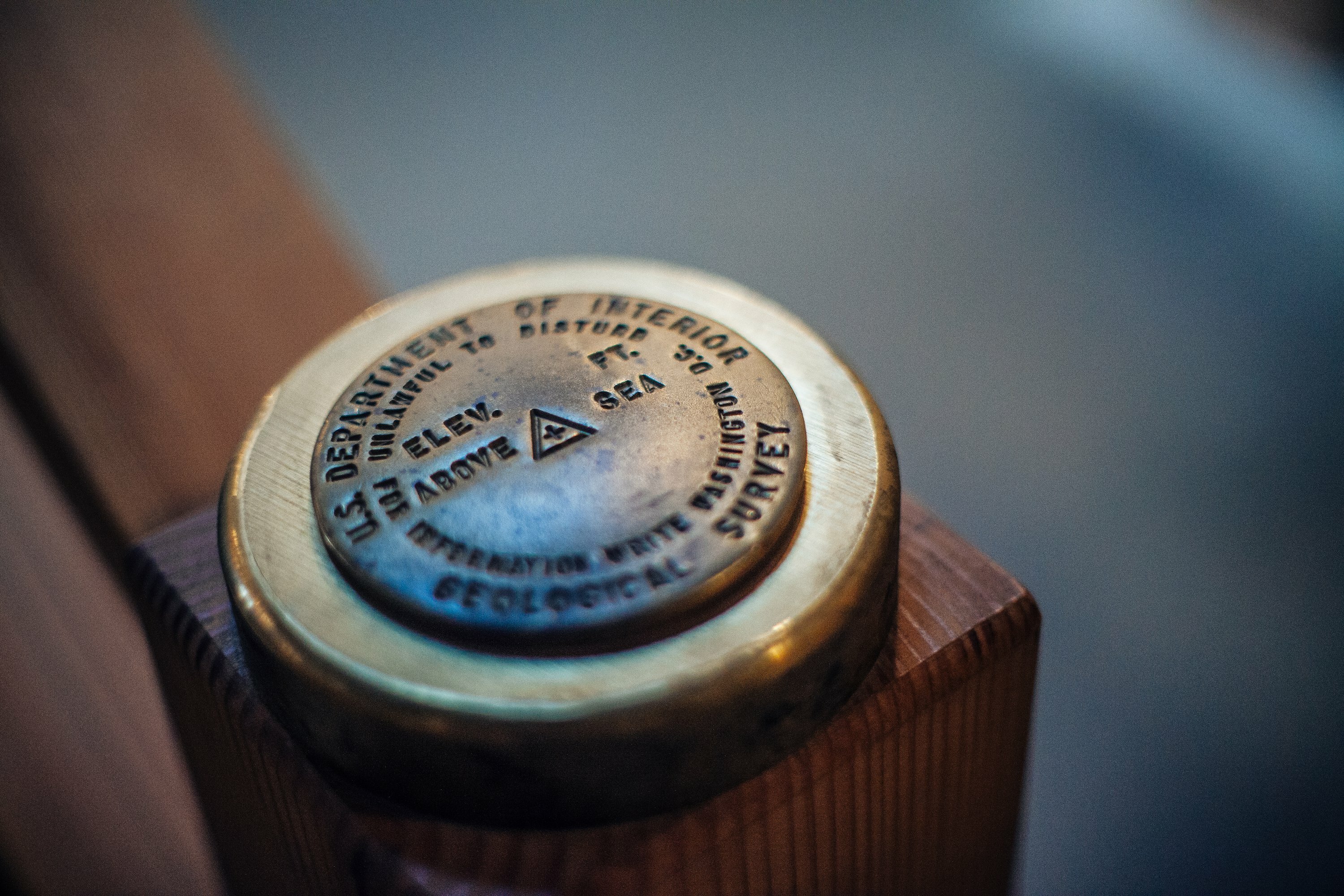 Brass U.S. Department of Interior Geological Survey elevation marker set into a wood post at the Bard