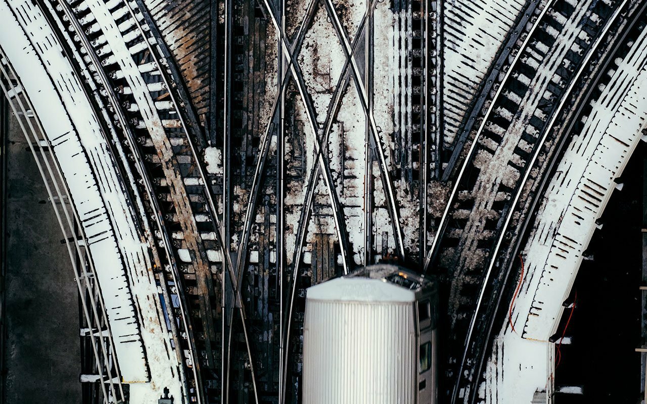 Overhead view of converging railway tracks with a train car at the junction