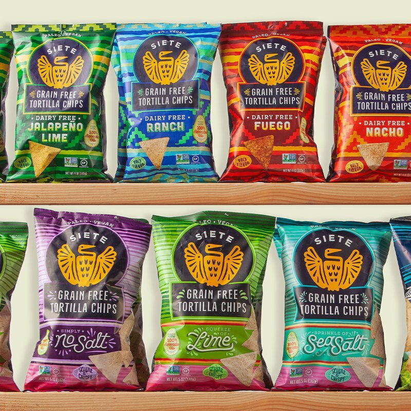 Lineup of Siete grain free tortilla chip bags in Jalapeno Lime, Ranch, Fuego, Nacho, Lime and Sea Salt
