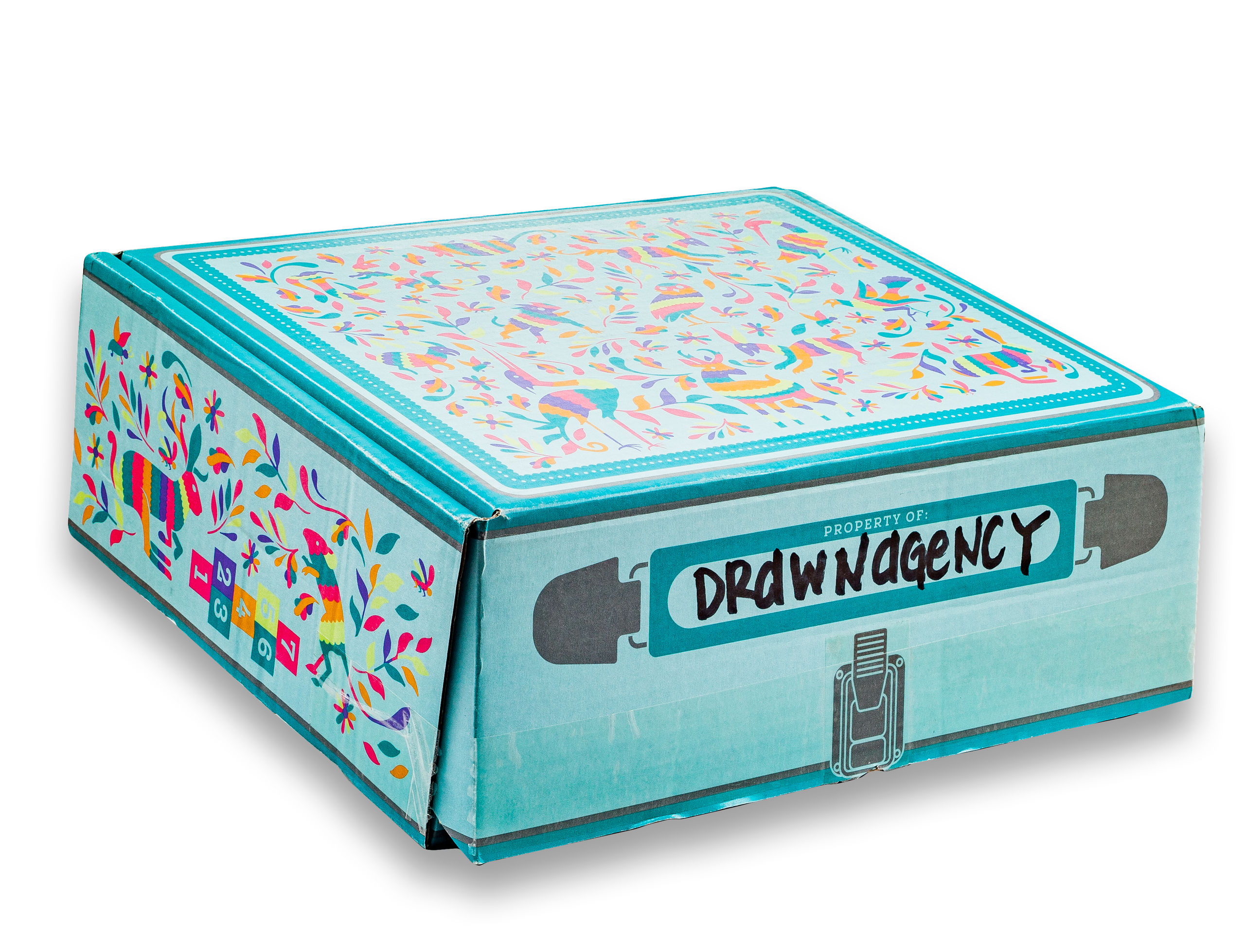 Teal box with colorful Otomi folk-art print labeled Property of Drawn Agency