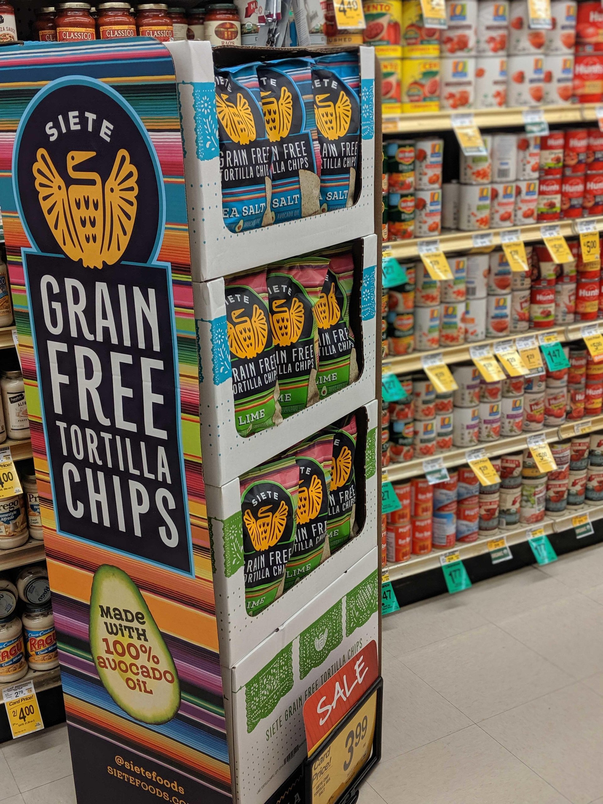 Siete grain-free tortilla chips display tower in a grocery aisle marked SALE 3.99