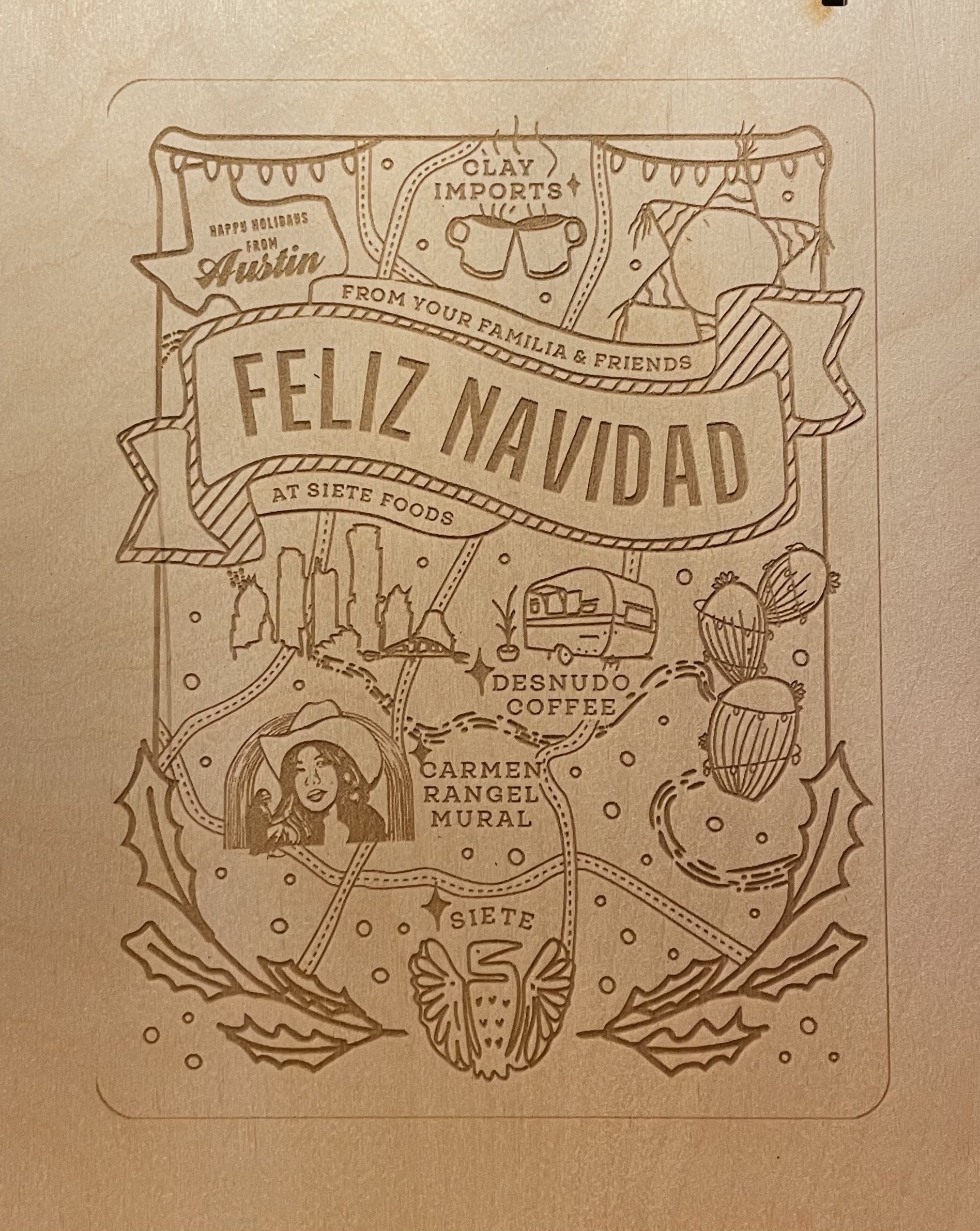 Laser-engraved wood card reading Feliz Navidad from Siete Foods with Austin map art
