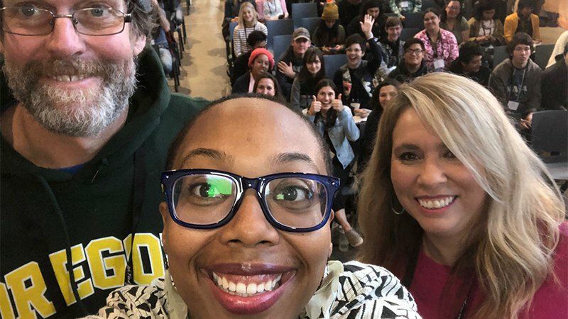 Selfie of three smiling attendees in a lecture hall at the Built Oregon Festival in Portland