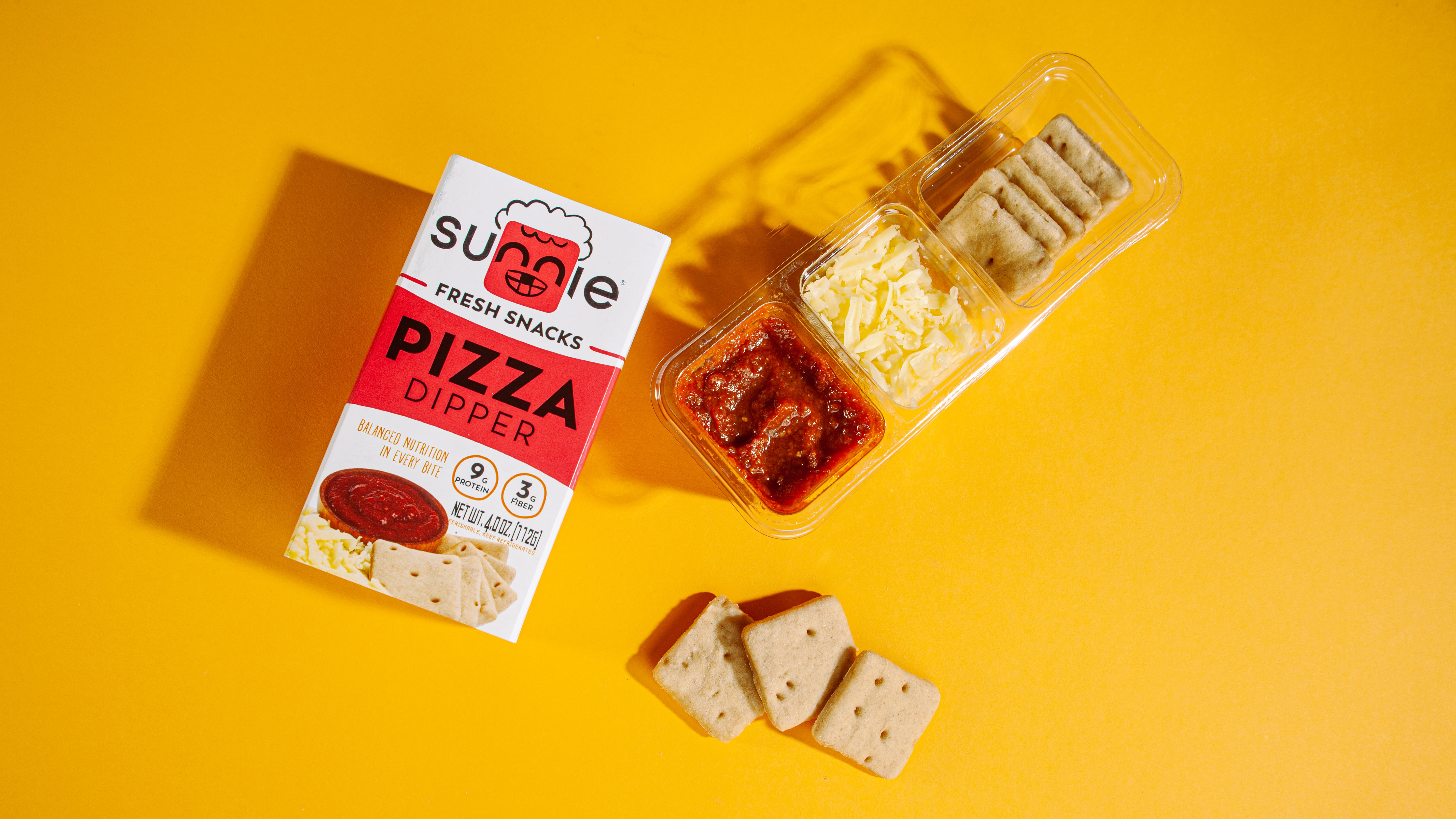 Sunnie Pizza Dipper snack pack with crackers, cheese and marinara on yellow